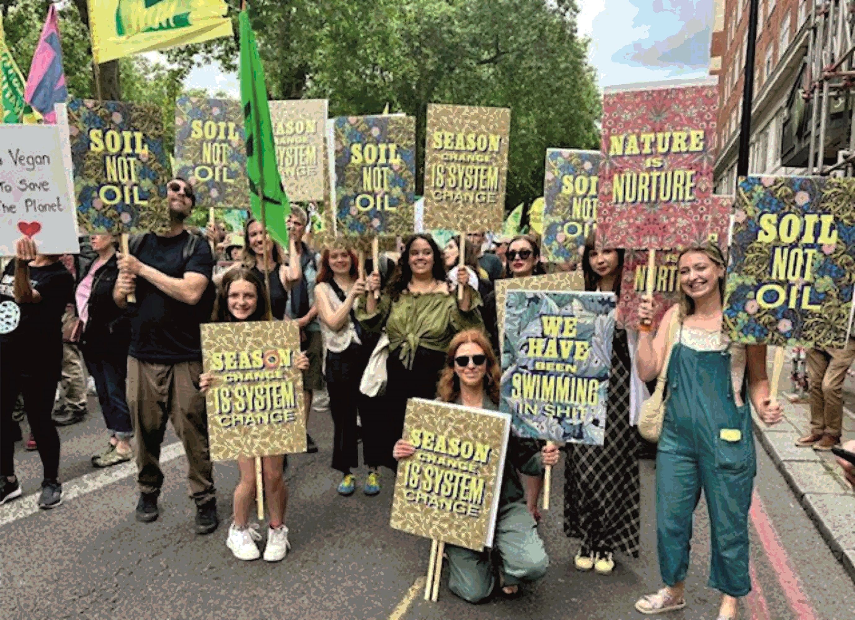 The team at House of Hackney holding their placards