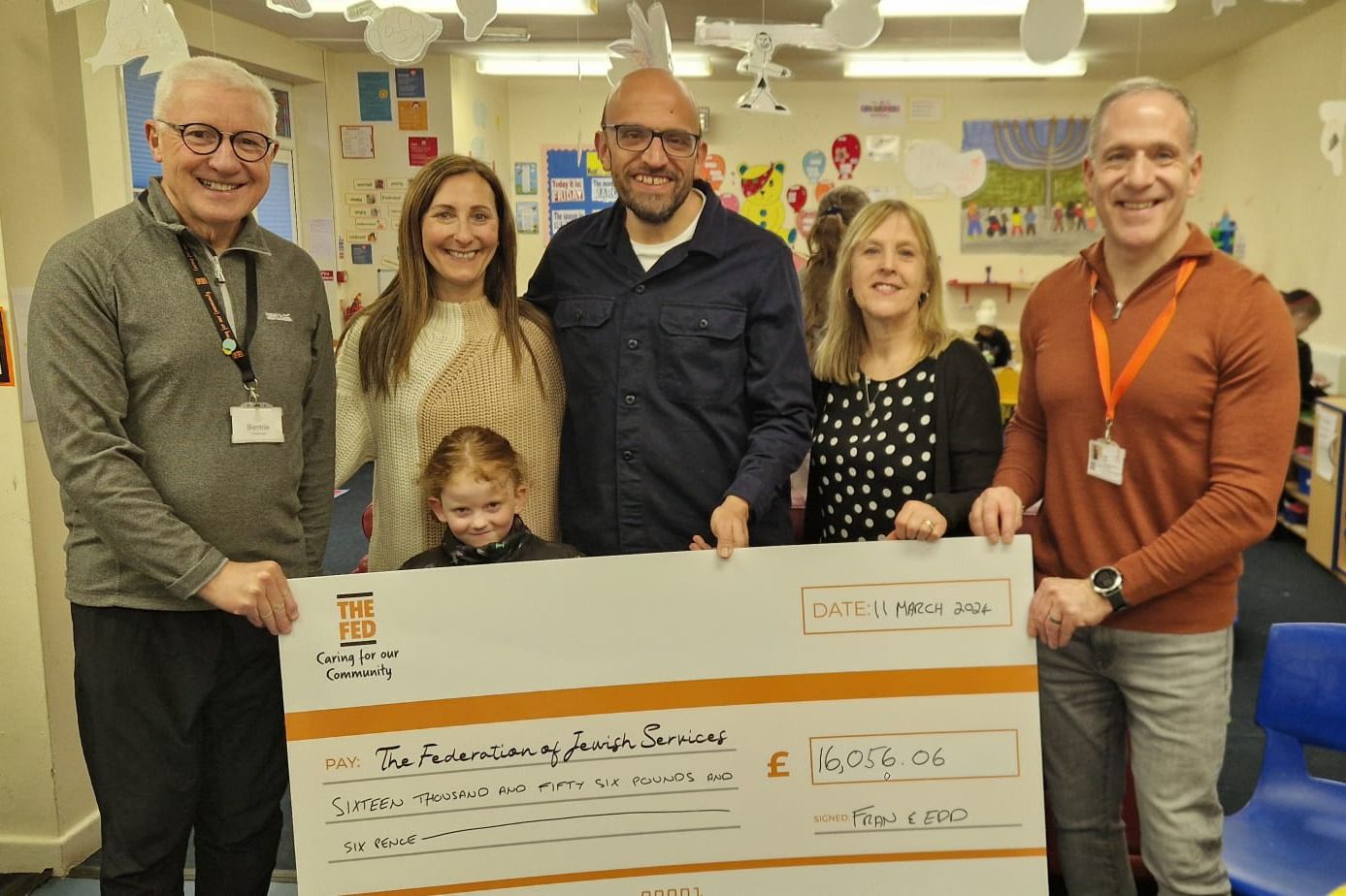 A group of people holding a foamex cheque