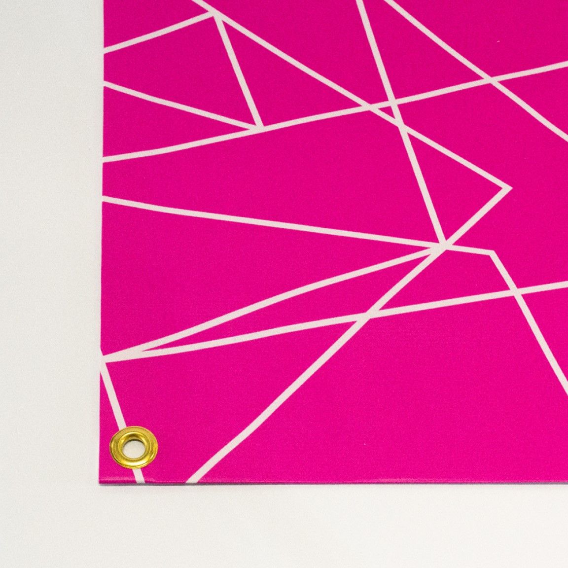 Close-up of a PVC outdoor banner with reinforced eyelets for secure installation.